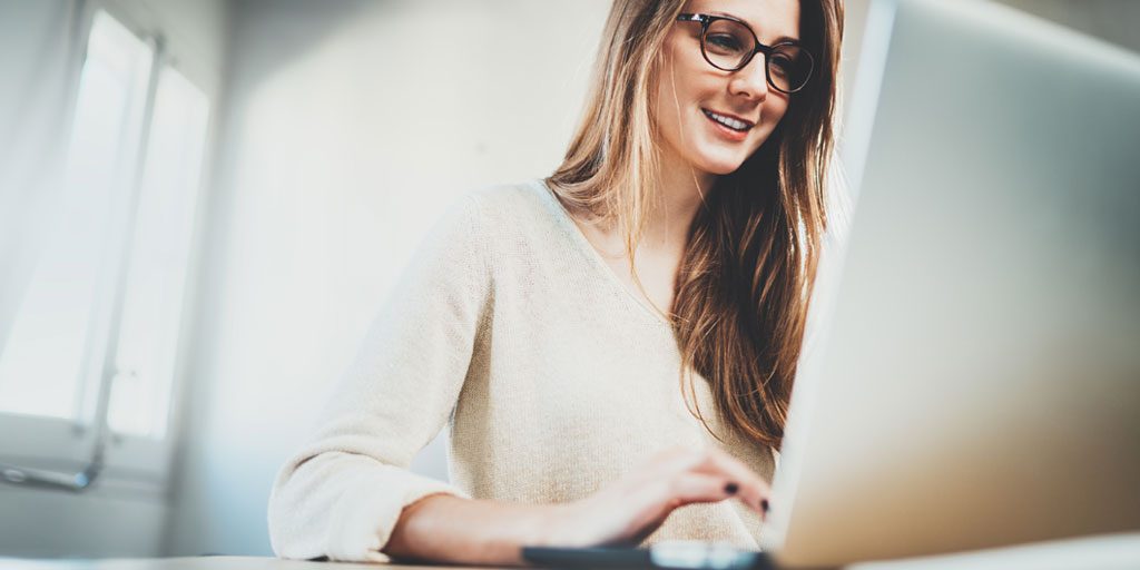 woman smiling working on computer