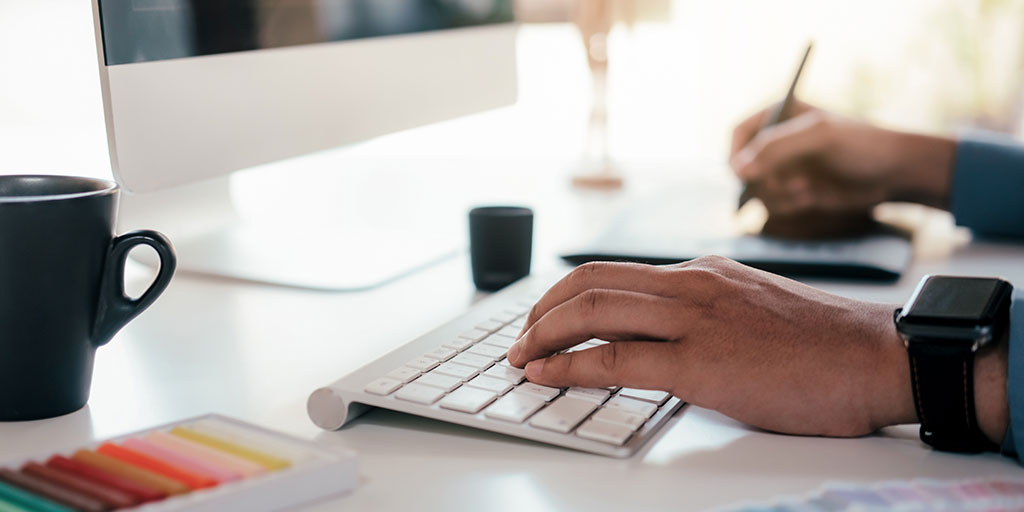 Designer working on tablet and computer